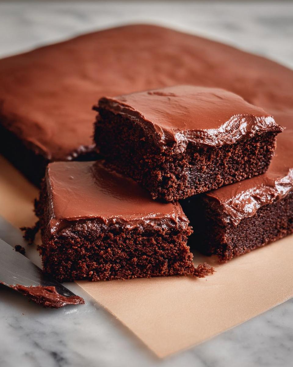 Close-up of rich chocolate cake ideas recipes slices with smooth chocolate frosting.