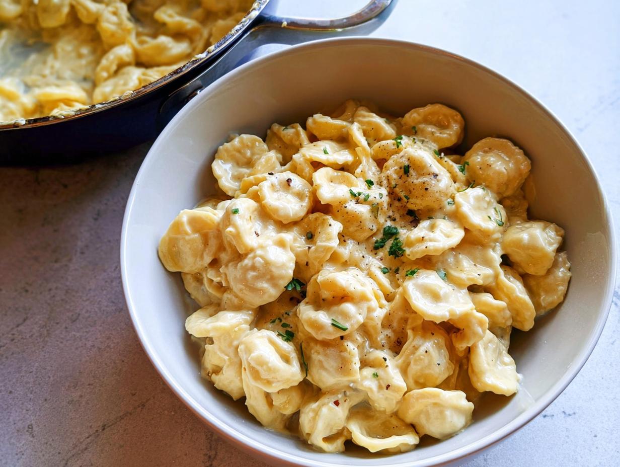 A bowl of creamy orecchiette pasta, a simple and delicious easy dinner recipe, garnished with herbs.