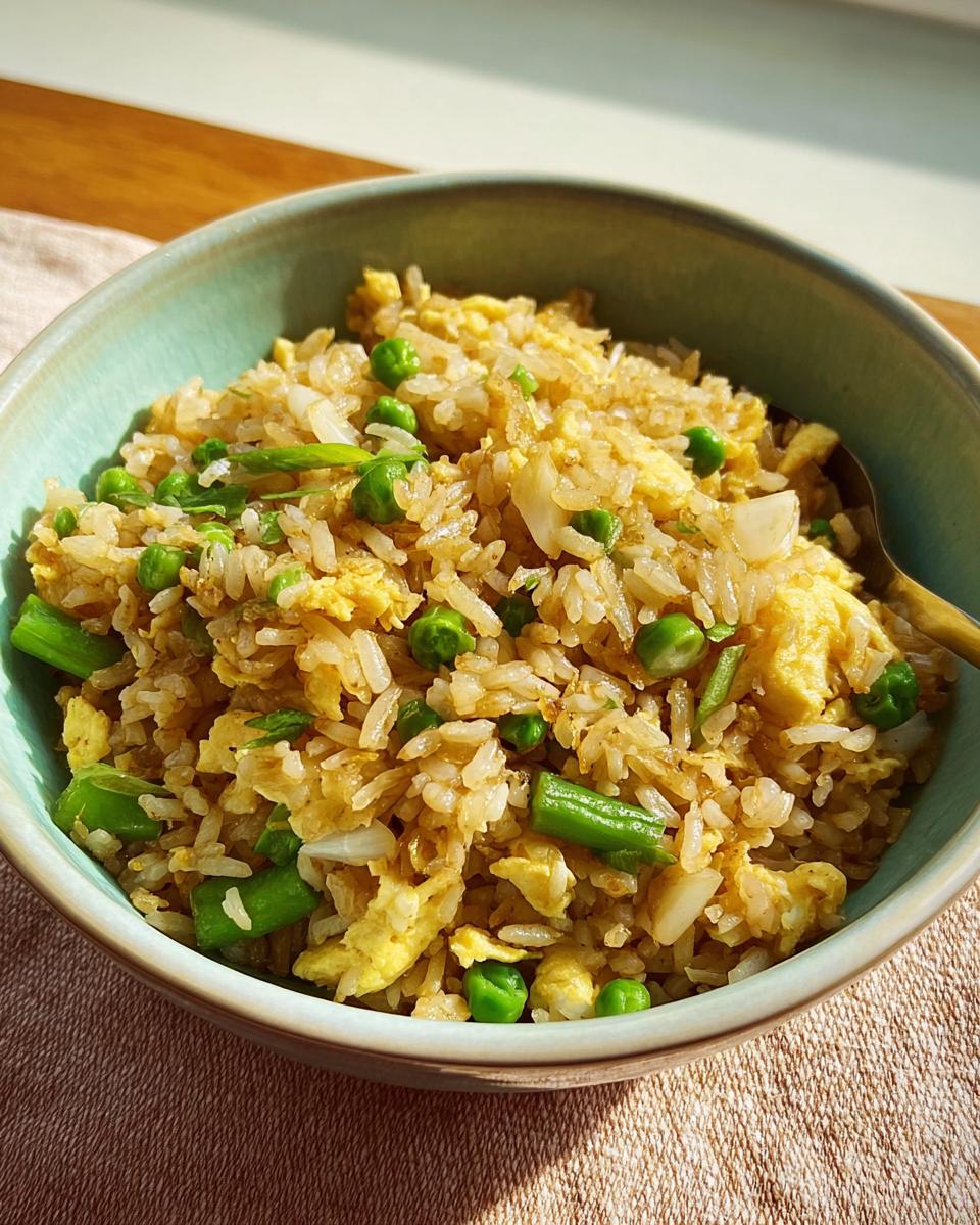 A bowl of egg fried rice with peas and green beans, part of 7-Ingredient Egg Recipes.