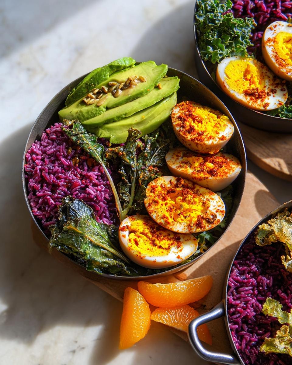 A vibrant bowl featuring The Ultimate Egg Recipes Guide for Beginners, with sliced hard-boiled eggs, avocado, purple rice, and greens.